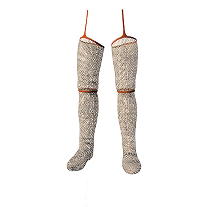 Two mail stockings stand side by side. They have leather laces around the knees and at the top.