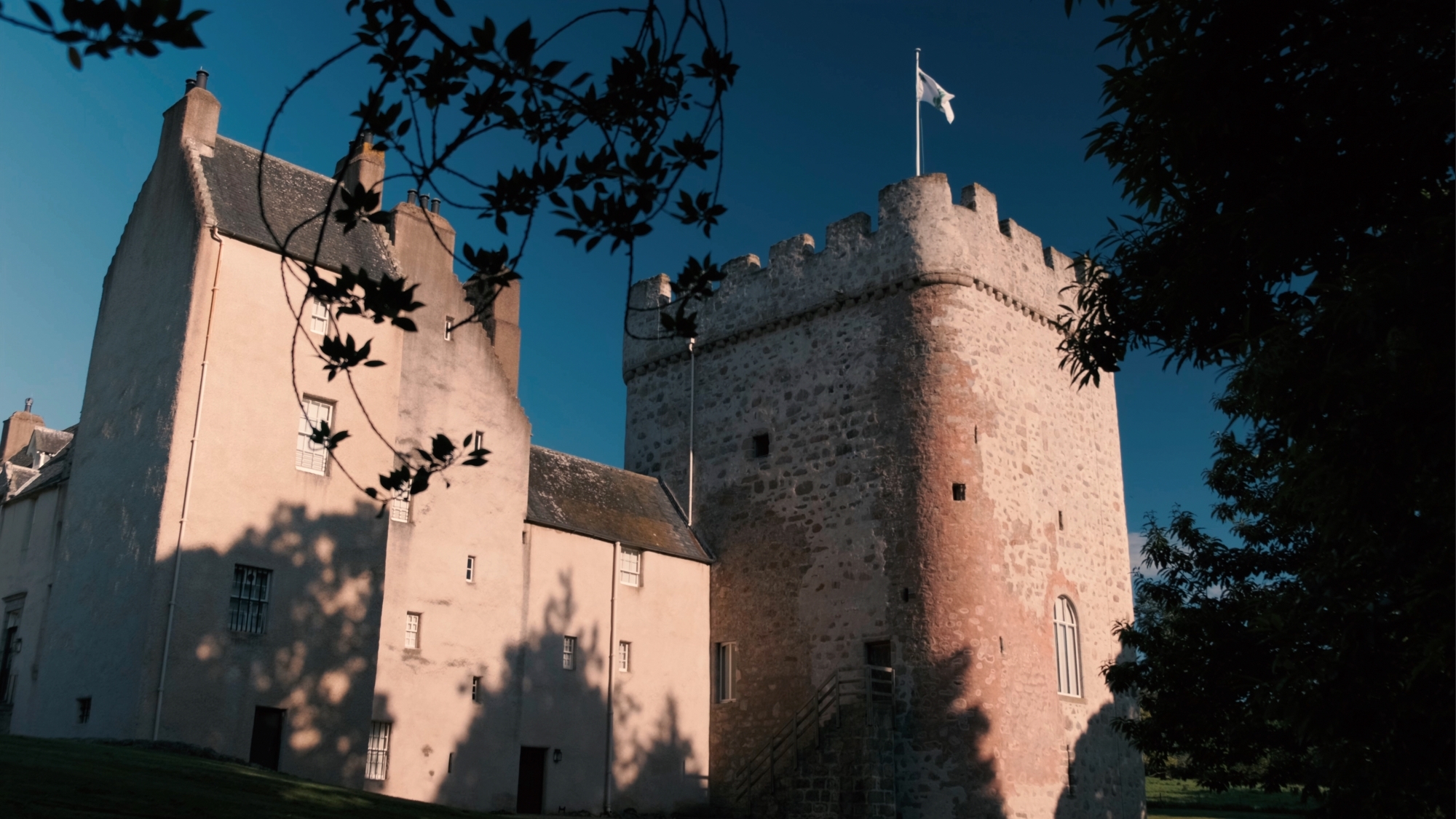 Drum Castle with a flag flying above its medieval tower
